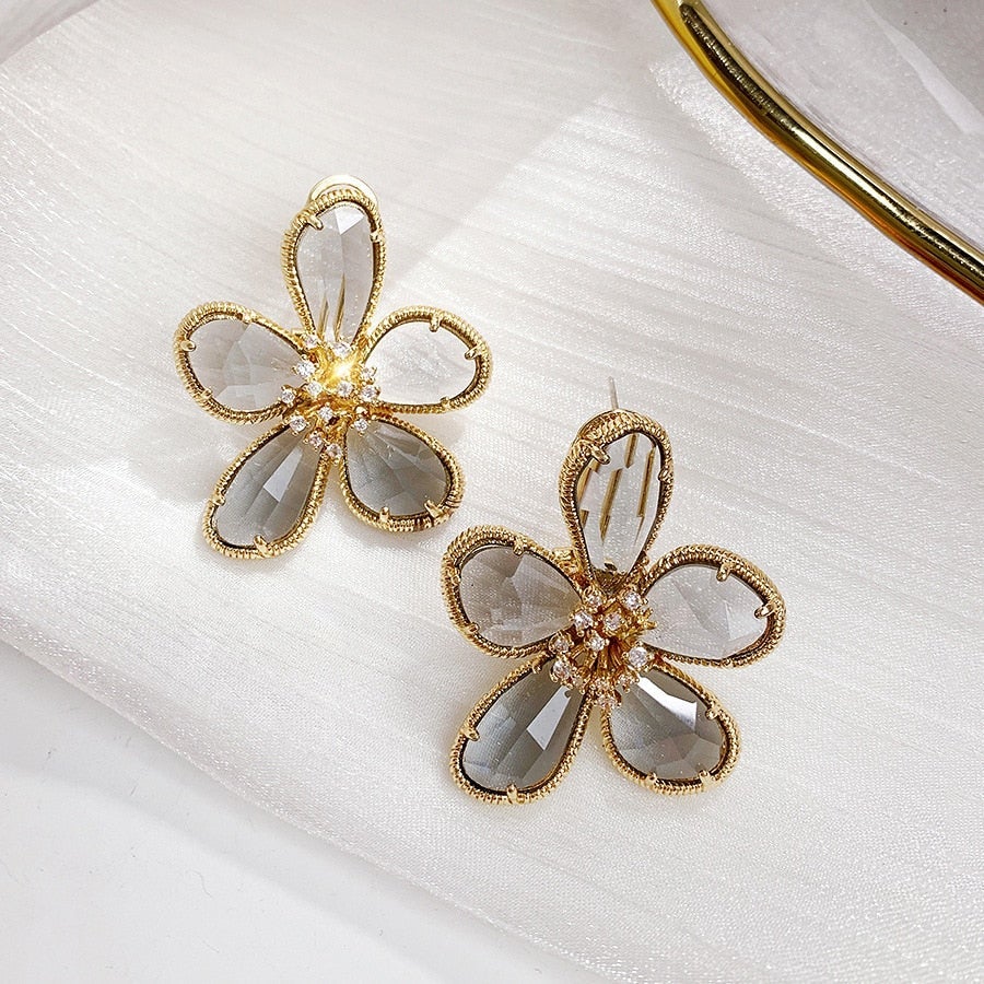 Caravanas Rotativos Flor de la Riqueza con Circonitas Incrustadas